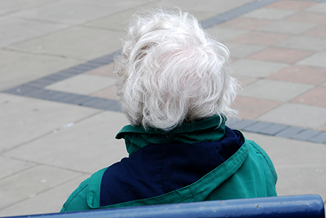 Elderly lady sat on bench