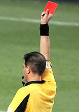 Referee holding a red card